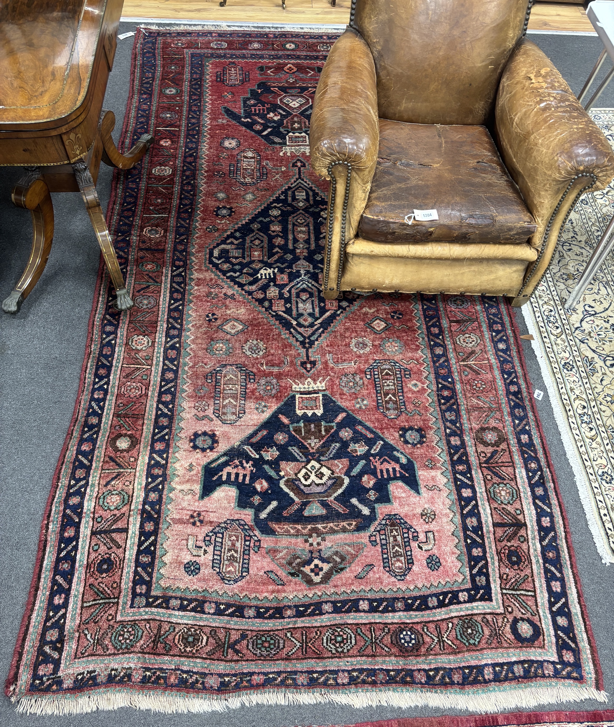 An Heriz red ground medallion rug 280 x 137cm